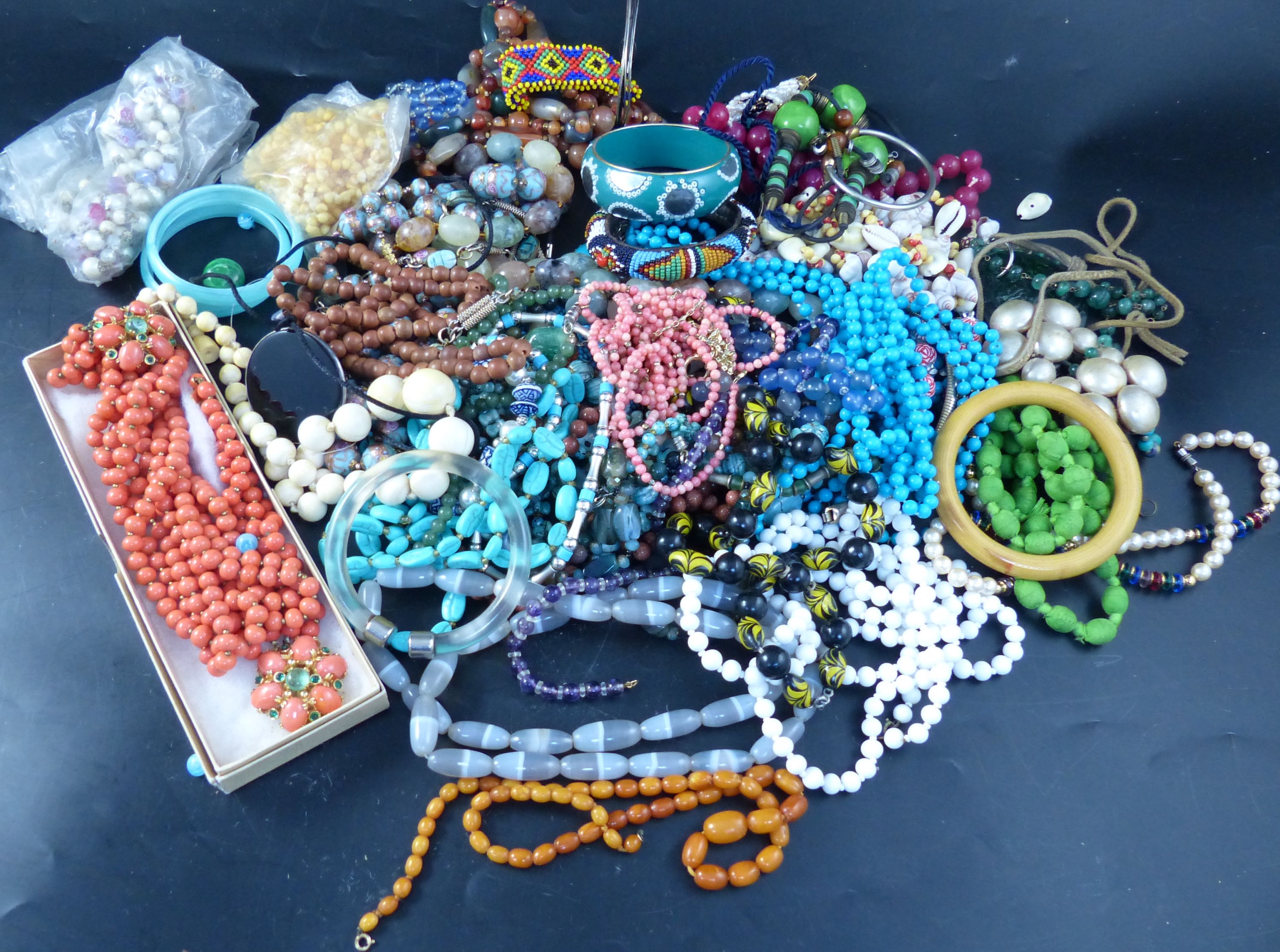 A collection of costume jewellery, principally necklaces, including an egg yolk amber bead necklace